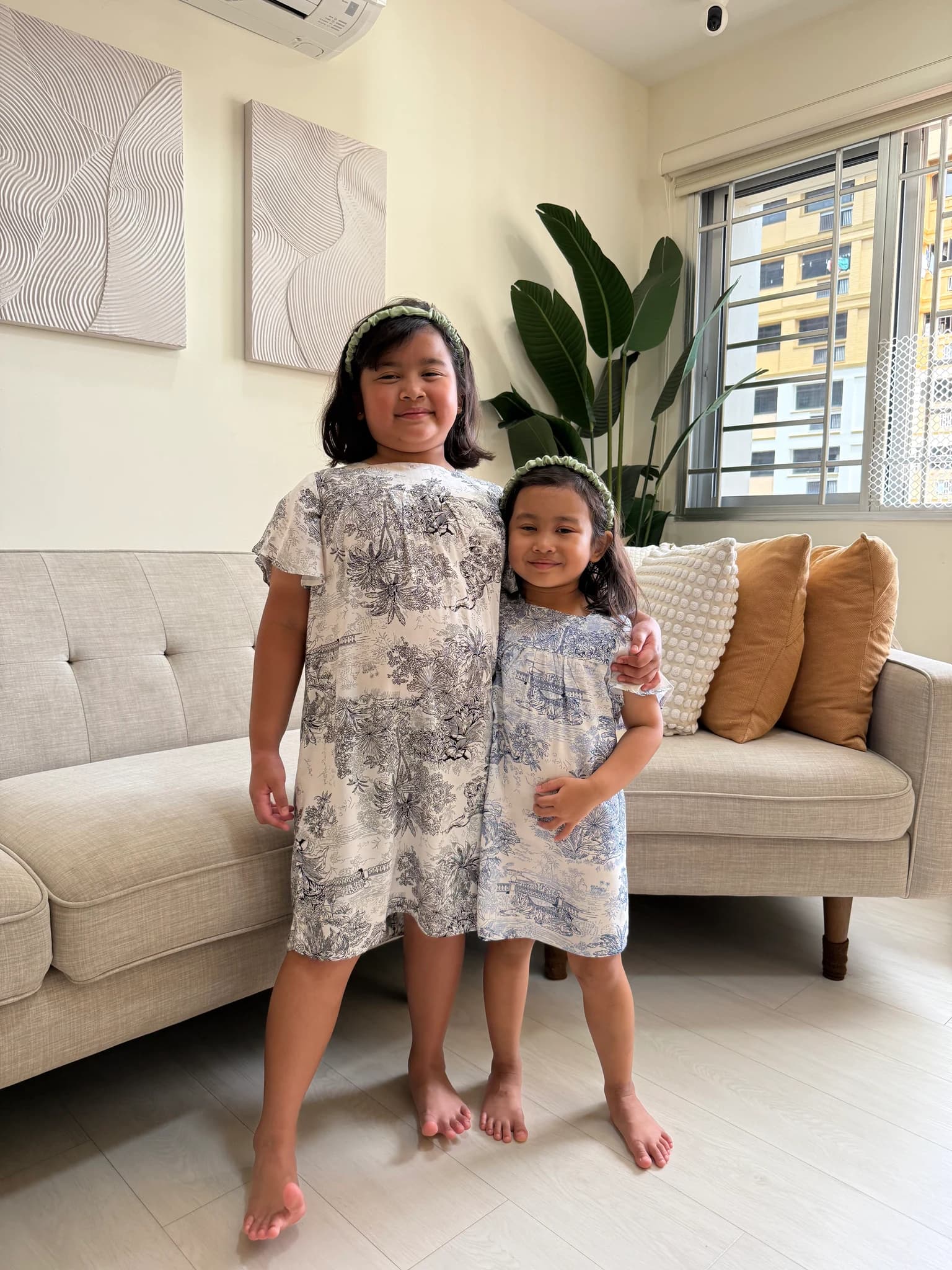 Two girls in matching toile dresses